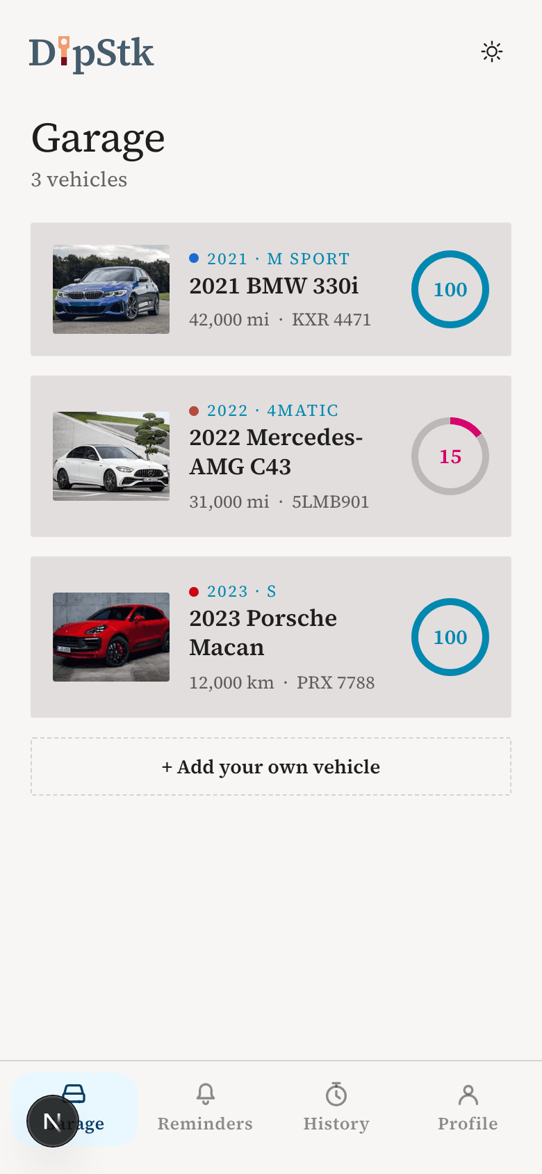 The DipStk garage screen showing three tracked vehicles, each with mileage and status at a glance